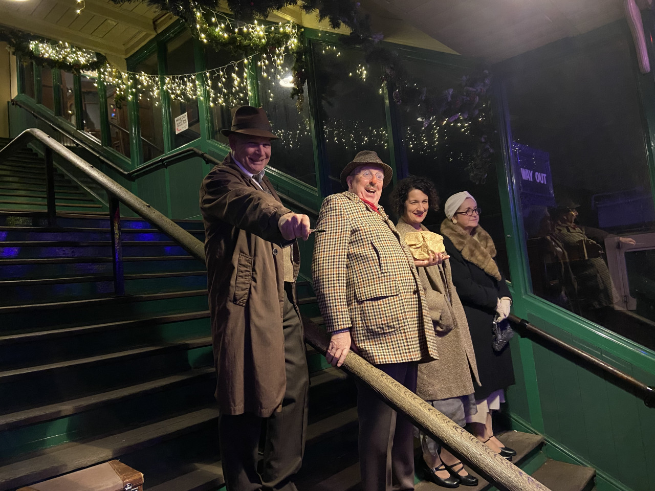 Detective Inspector Archie Balls and company standing on the train station platform.