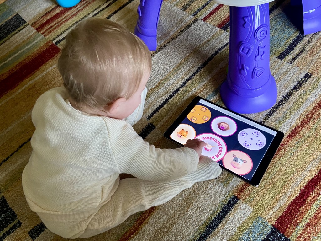 Oliver playing with his drum kit