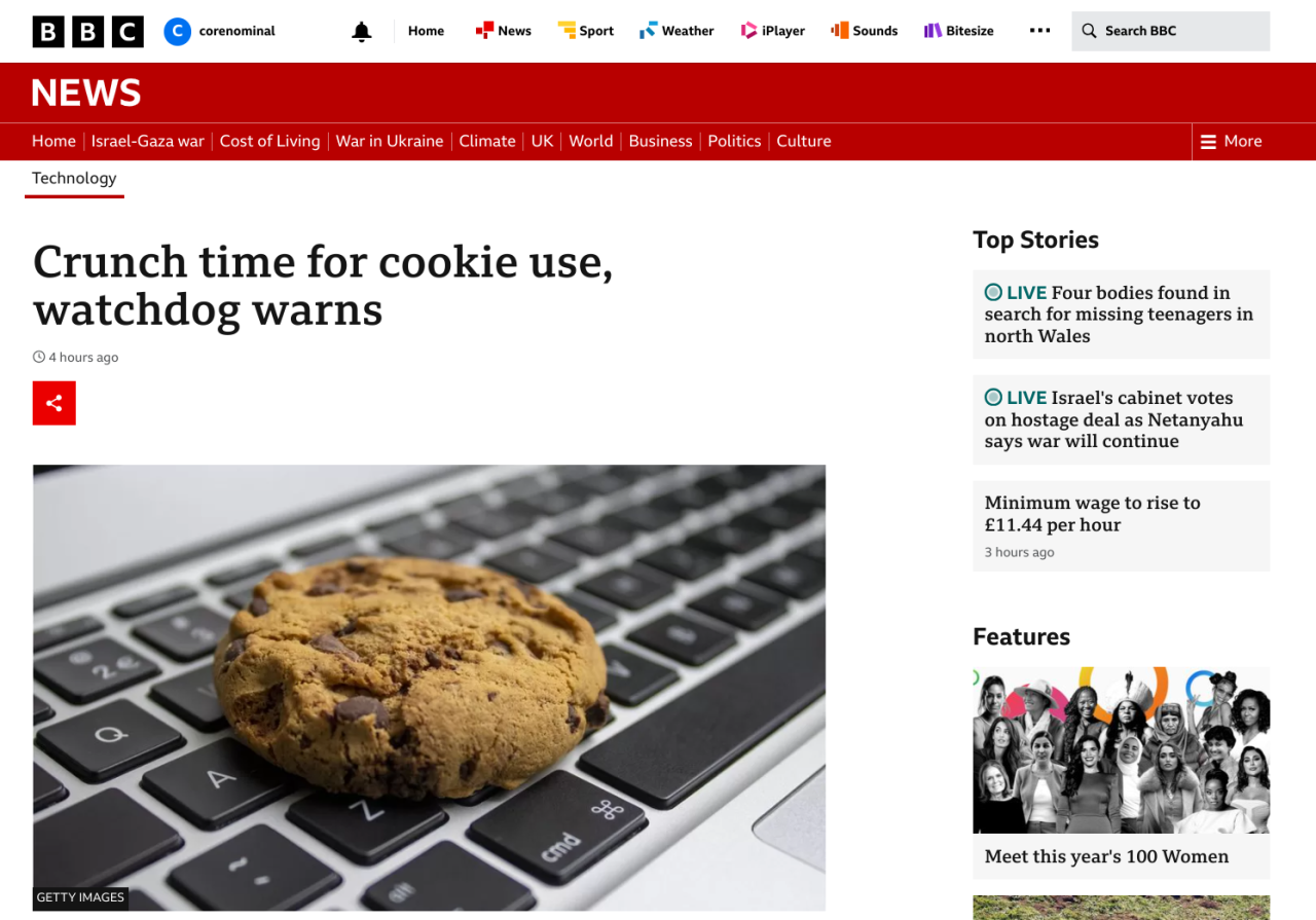 Screenshot of the BBC News website showing a picture of a cookie on a laptop keyboard.